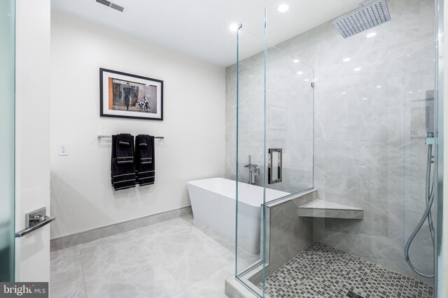 100 Harborview Dr Unit 2107, Baltimore, MD 21230 - full bathroom featuring a shower stall, a soaking tub, and baseboards