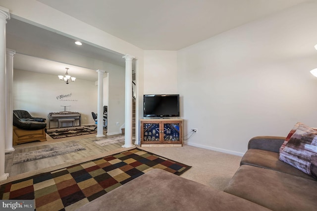 living area featuring recessed lighting, baseboards, a notable chandelier, and decorative columns