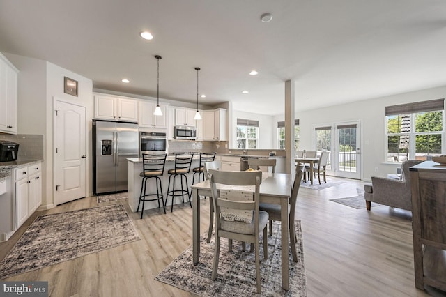 dining room featuring light wood-style floors and recessed lighting