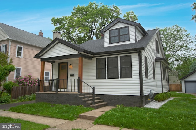 14 Titus Ave, Lawrence, NJ 08648 - bungalow-style home featuring covered porch, a shingled roof, and a front yard