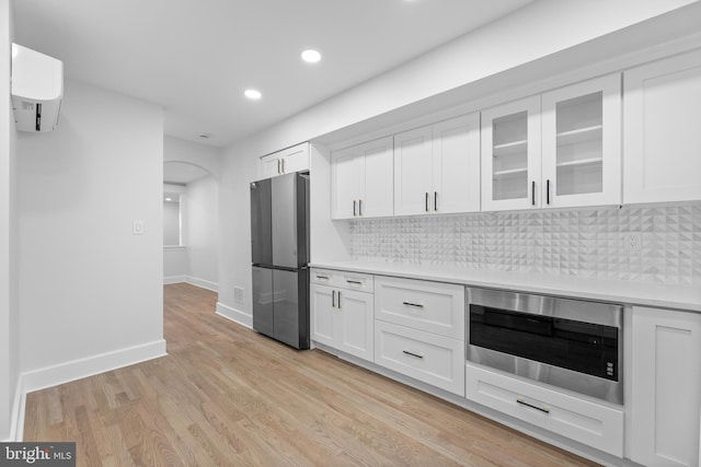 14 Titus Ave, Lawrence, NJ 08648 - kitchen featuring appliances with stainless steel finishes, light countertops, arched walkways, recessed lighting, and white cabinetry