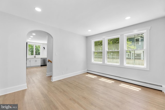 14 Titus Ave, Lawrence, NJ 08648 - unfurnished room featuring arched walkways, a baseboard radiator, light wood finished floors, baseboards, and recessed lighting