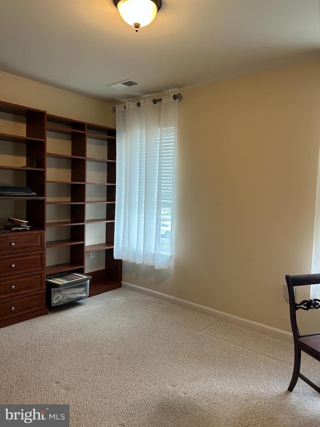 unfurnished room featuring carpet floors and baseboards