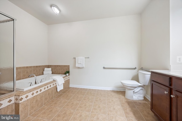 full bathroom with toilet, a garden tub, vanity, baseboards, and tile patterned flooring