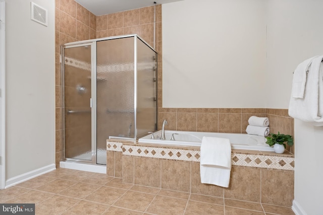 full bathroom featuring a shower stall, a bath, and tile patterned floors