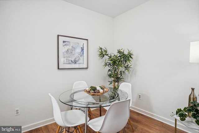 dining room with wood finished floors and baseboards