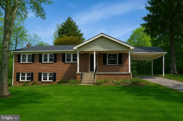8814 Lafayette Dr, Owings, MD 20736 - view of front of property with dirt driveway, an attached carport, a front lawn, a chimney, and brick siding
