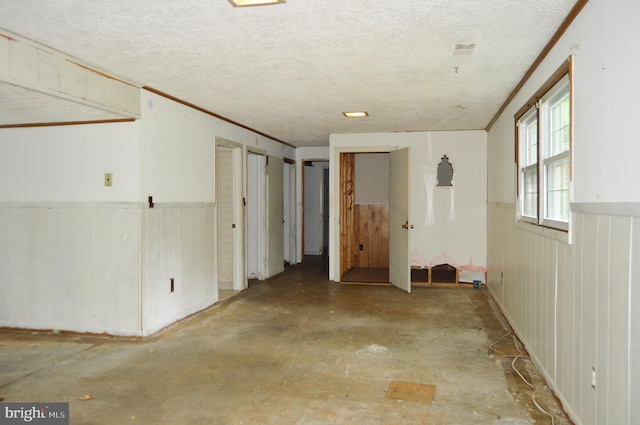 8814 Lafayette Dr, Owings, MD 20736 - basement featuring a textured ceiling and a wainscoted wall