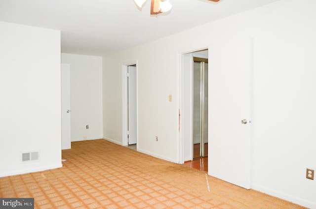 8814 Lafayette Dr, Owings, MD 20736 - unfurnished room featuring light colored carpet, baseboards, and a ceiling fan