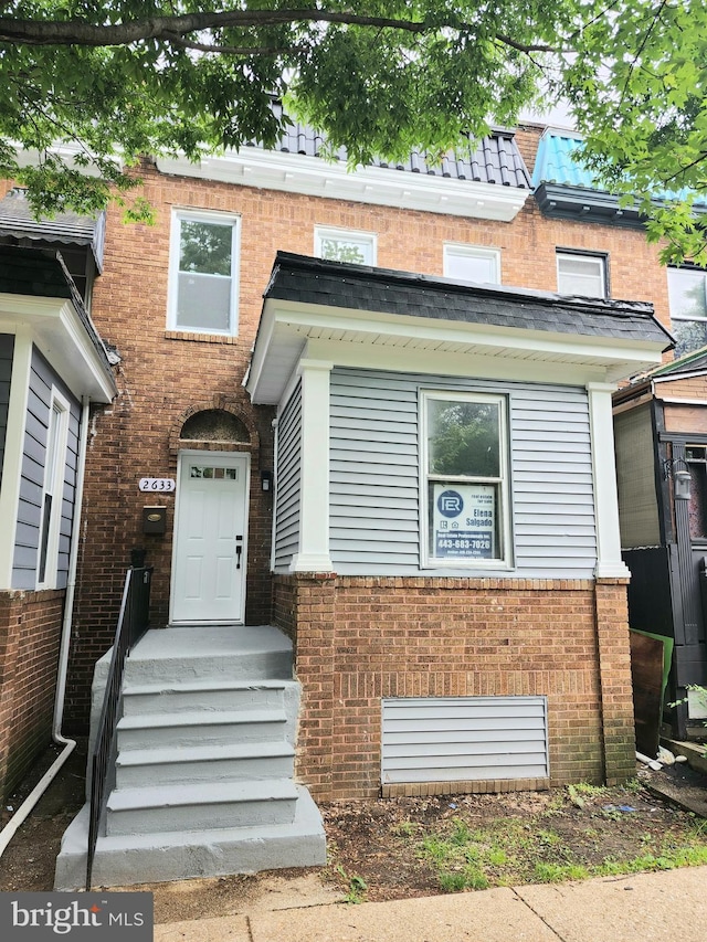 view of front of home featuring brick siding