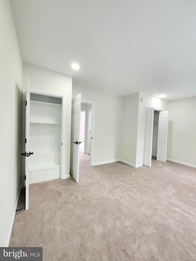 unfurnished bedroom with recessed lighting, baseboards, and carpet floors