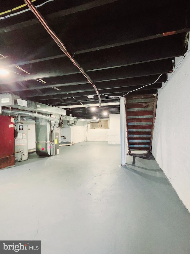 unfinished basement featuring heating unit and gas water heater