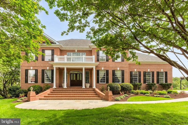13457 Charolais Ct, Highland, MD 20777 - colonial-style house featuring a balcony, brick siding, a front lawn, and french doors