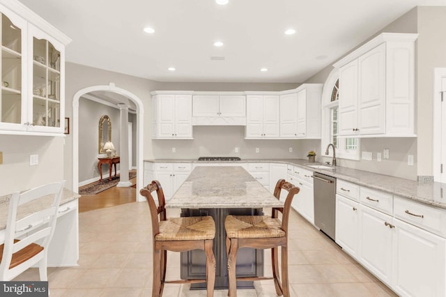 13457 Charolais Ct, Highland, MD 20777 - kitchen featuring appliances with stainless steel finishes, a breakfast bar, arched walkways, white cabinets, and recessed lighting