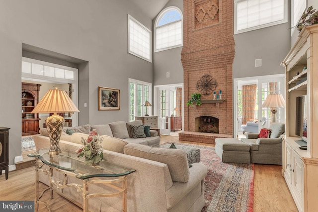 13457 Charolais Ct, Highland, MD 20777 - living room with a towering ceiling, light wood-type flooring, and a fireplace