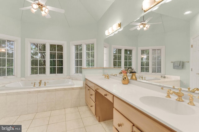 13457 Charolais Ct, Highland, MD 20777 - bathroom with ceiling fan, tile patterned floors, a garden tub, high vaulted ceiling, and double vanity