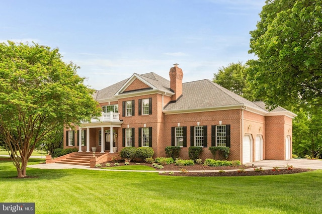13457 Charolais Ct, Highland, MD 20777 - rear view of house with a balcony, brick siding, driveway, a garage, and a yard