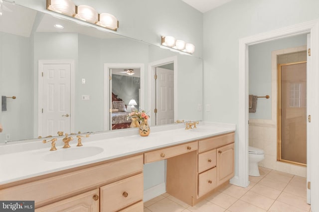 13457 Charolais Ct, Highland, MD 20777 - ensuite bathroom with tile patterned flooring, toilet, double vanity, a shower stall, and tile walls