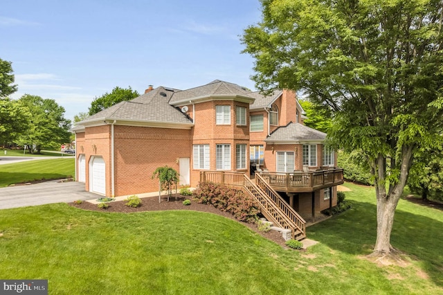 13457 Charolais Ct, Highland, MD 20777 - rear view of house with brick siding, a wooden deck, a lawn, and driveway