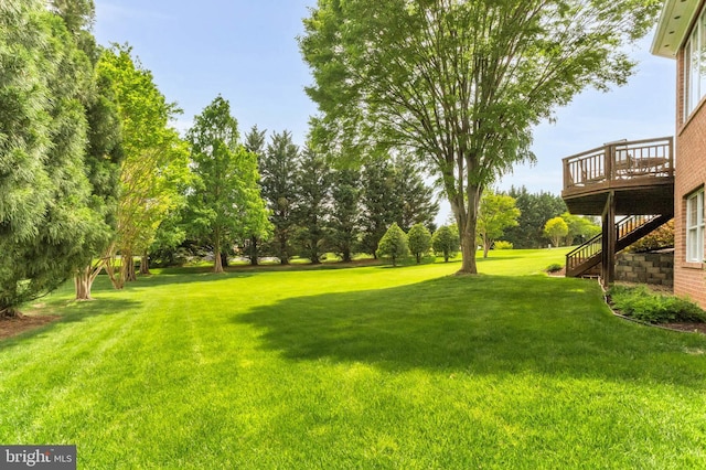 13457 Charolais Ct, Highland, MD 20777 - view of grassy yard with a deck, stairs, and view of wooded area