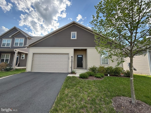 view of front of property with a front lawn, driveway, and an attached garage