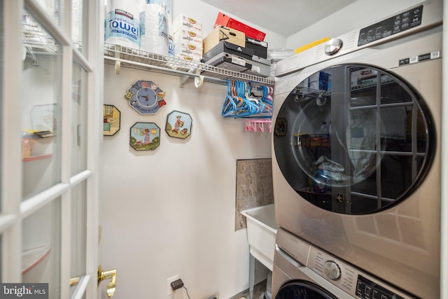 laundry area with laundry area and stacked washer / dryer