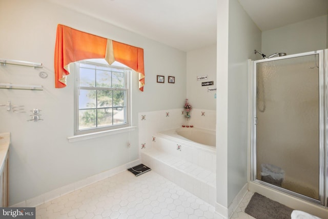 bathroom with tile patterned floors, a bath, baseboards, and a stall shower