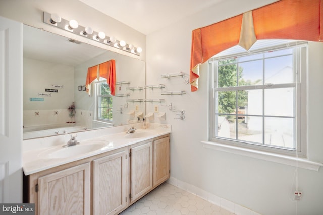 bathroom featuring a sink, plenty of natural light, and visible vents