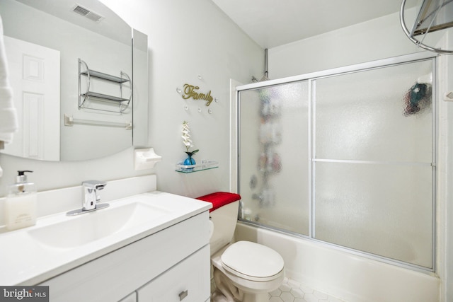 full bathroom with toilet, vanity, visible vents, and bath / shower combo with glass door