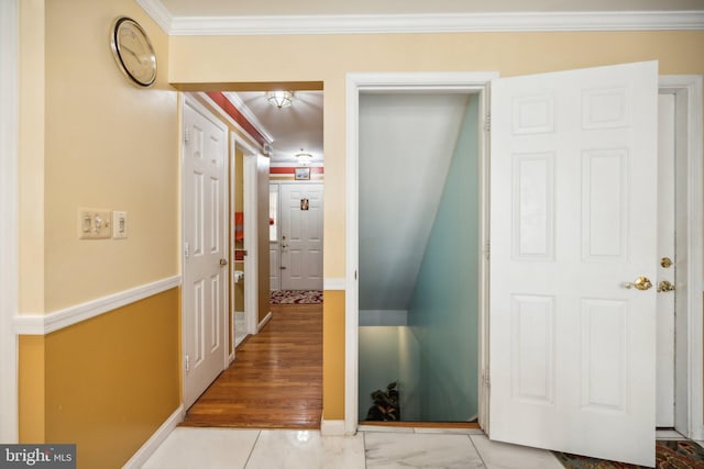 hallway with crown molding and baseboards