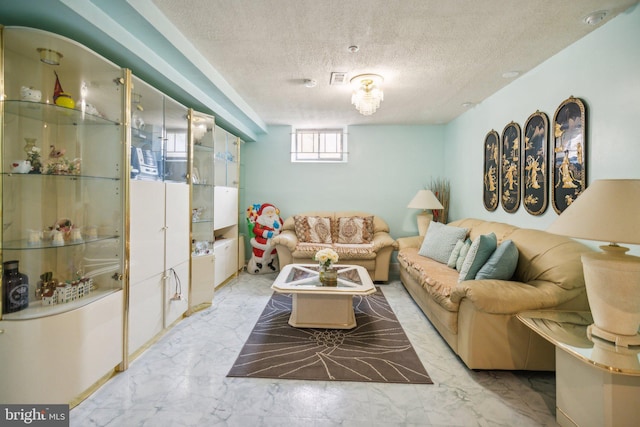 living room with a textured ceiling and marble finish floor