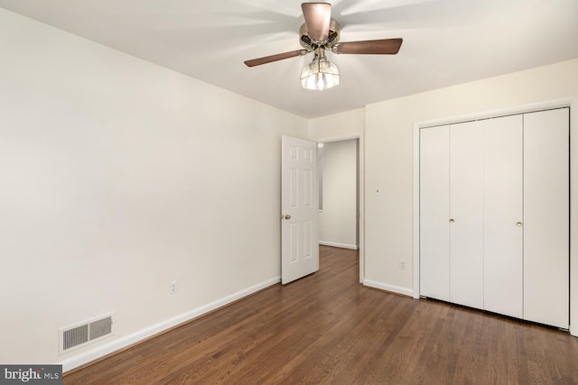 unfurnished bedroom with wood finished floors, baseboards, a closet, and ceiling fan