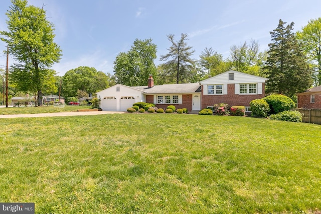 split level home featuring an attached garage, concrete driveway, brick siding, and a chimney