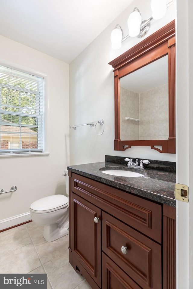 bathroom featuring tile patterned floors, vanity, and toilet