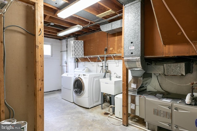 basement with washer and clothes dryer and a sink