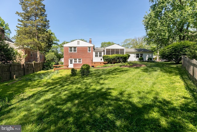 view of yard with a sunroom and a deck