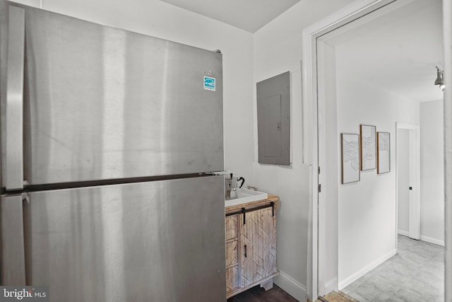 bathroom with electric panel, vanity, and baseboards