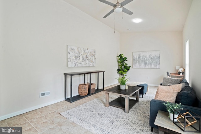 living room featuring a ceiling fan, baseboards, tile patterned flooring, and lofted ceiling