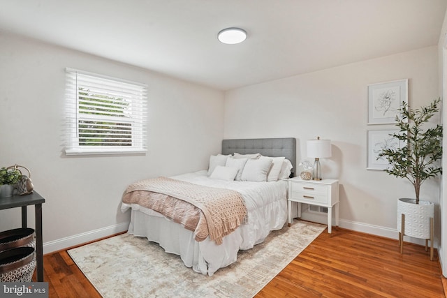 bedroom featuring wood finished floors and baseboards