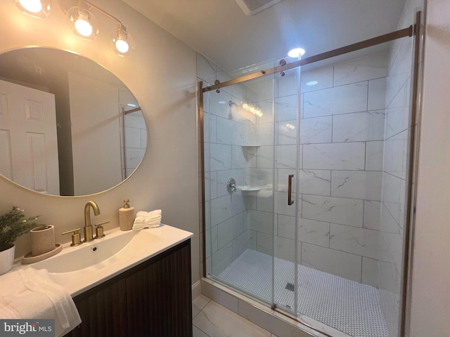 bathroom with tile patterned floors, a stall shower, and vanity