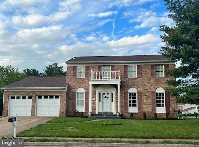 colonial home featuring an attached garage, brick siding, driveway, and a balcony