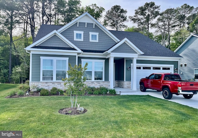 craftsman house with a front lawn, stone siding, a shingled roof, and a garage