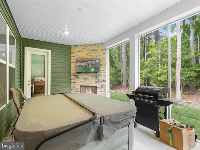 32019 Carlisle Ct, Frankford, DE 19945 - sunroom featuring a fireplace, a hot tub, and healthy amount of natural light