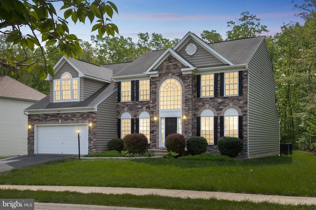 2 Raydan Way N, East, MD 21901 - colonial home featuring asphalt driveway, stone siding, a front yard, central air condition unit, and roof with shingles
