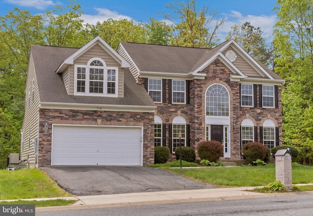 2 Raydan Way N, East, MD 21901 - view of front of property featuring asphalt driveway, a garage, roof with shingles, and stone siding