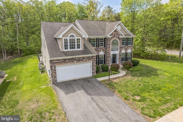 2 Raydan Way N, East, MD 21901 - view of front facade with stone siding, driveway, a garage, a front lawn, and roof with shingles