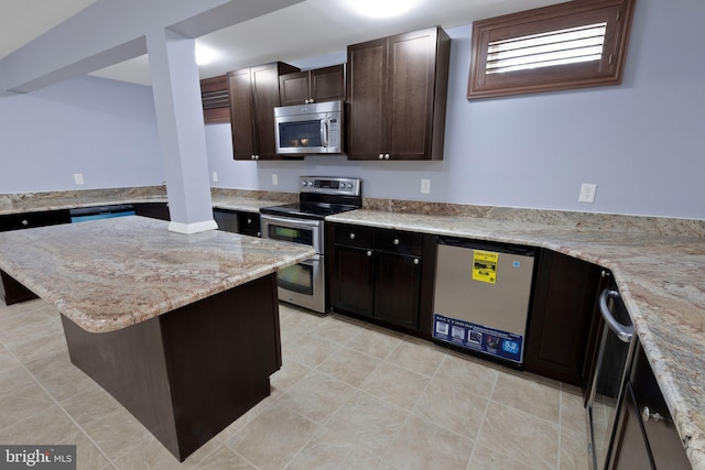 2 Raydan Way N, East, MD 21901 - kitchen featuring appliances with stainless steel finishes, a kitchen island, dark brown cabinets, and light stone countertops