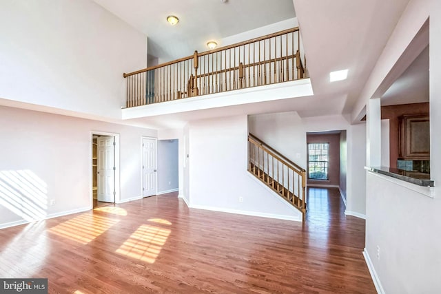 2 Raydan Way N, East, MD 21901 - unfurnished living room featuring stairway, a high ceiling, wood finished floors, and baseboards