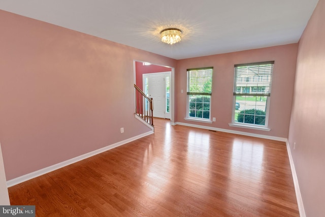 2 Raydan Way N, East, MD 21901 - empty room featuring wood finished floors, baseboards, stairs, and a chandelier