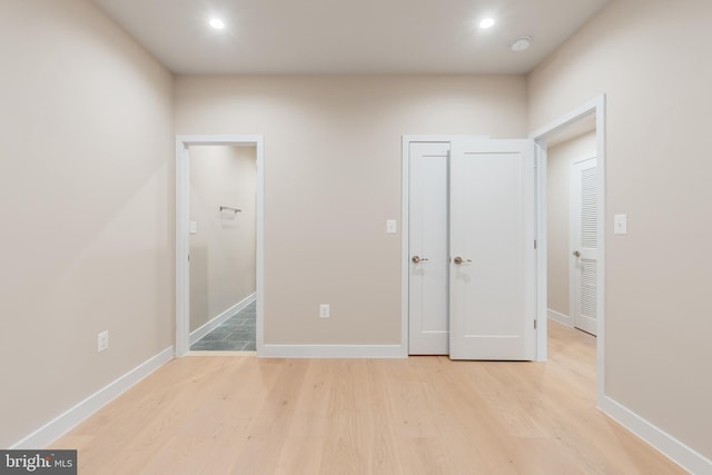 unfurnished bedroom with light wood finished floors, baseboards, and recessed lighting